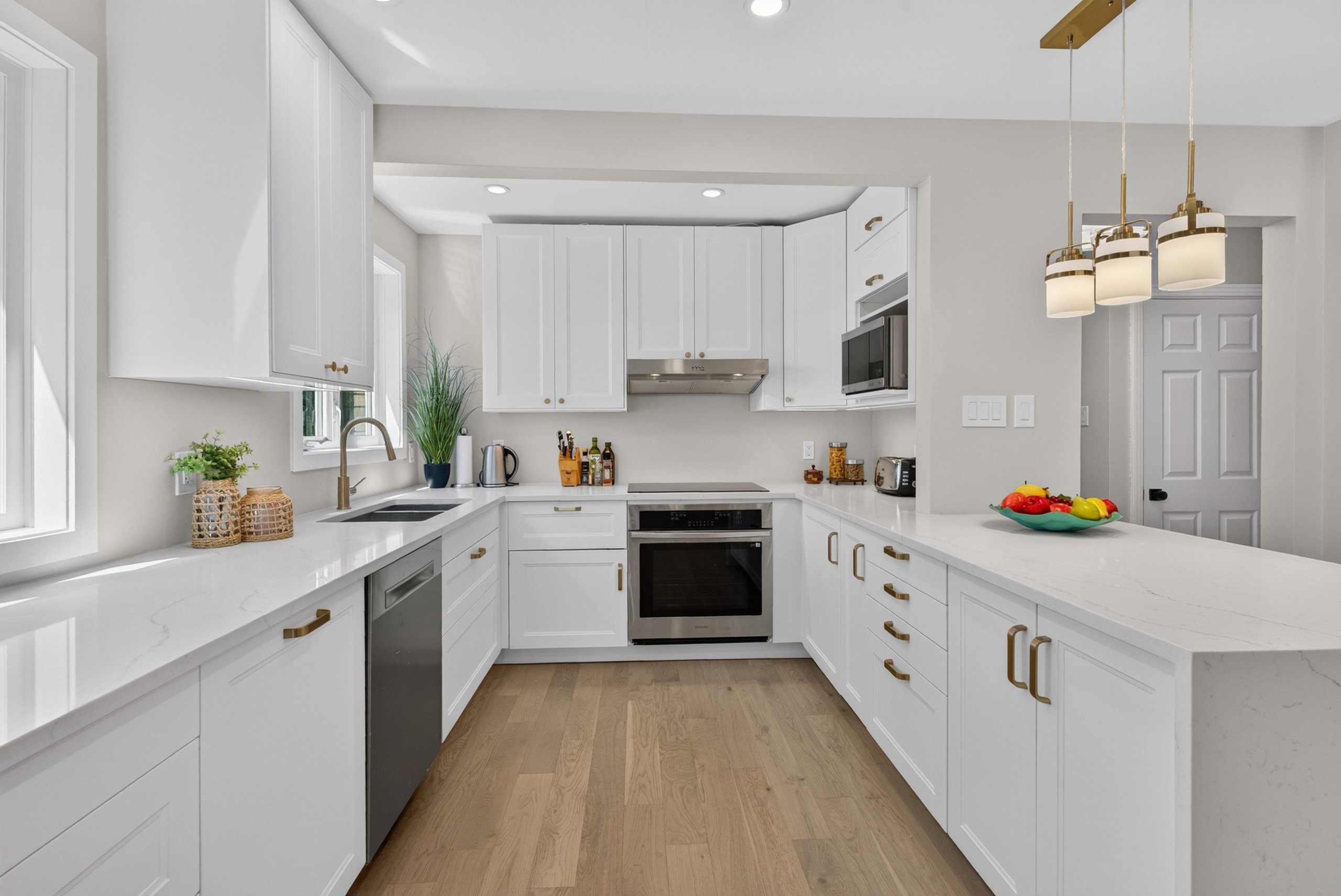 New chef's kitchen with quartz counters and gold hardware
